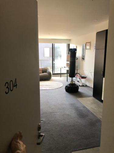 a room with a door open to a living room at Entire apartment with washer-dryer machine near Footscray in Melbourne