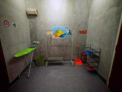 a room with a room with a table and a desk at Defaso Homestay Kota Marudu in Kampong Karungkon