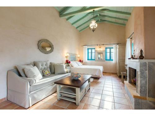 a living room with a couch and a table at Pandora in Pirgos Dhirou