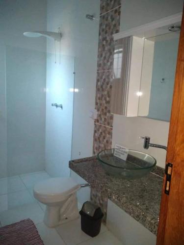 a bathroom with a sink and a toilet at Recanto Julia in Olímpia