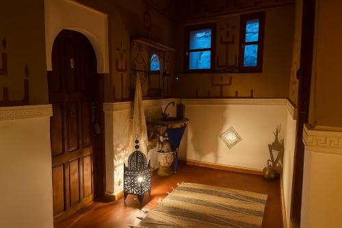 an empty room with a door and a rug at Auberge La Fibule Du Dades in Aït Idaïr