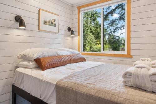 a bedroom with a large bed and a window at Eco Friendly Tiny Container Home Retreat in Camas
