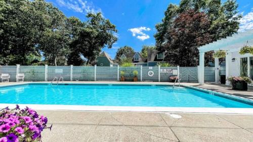 a swimming pool in a yard with a fence at Villa Signor in Norwich
