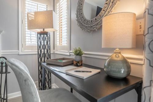 a desk with a lamp and a table with a chair at Villa Signor in Norwich