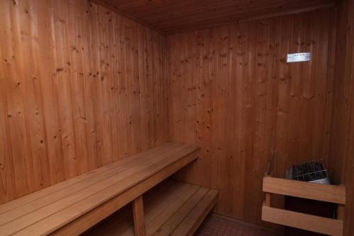 a small wooden sauna with a bench in it at Villa Signor in Norwich