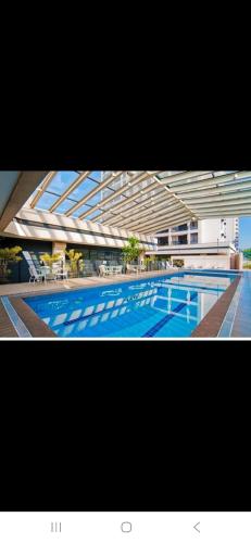 a large swimming pool in a large building at Nobile Congonhas in Sao Paulo