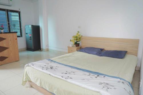 a bedroom with a large bed with blue pillows at Phương Anh 303DM2 in Hanoi