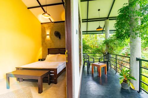a bedroom with a bed and a balcony at Traveller's Villa in Hatton