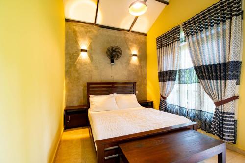 a small bedroom with a bed and a window at Traveller's Villa in Hatton
