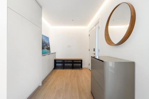 a hallway with a mirror on the wall at Luxury&Brand-new 3BD 2BTH House in Burnaby