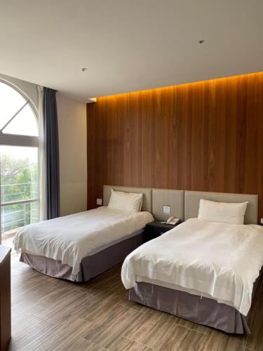 A bed or beds in a room at Hledu Hotel