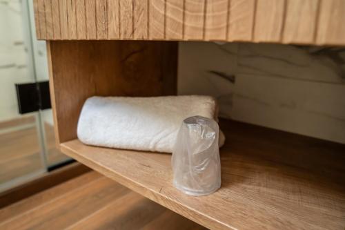a white towel and a plastic bag sitting on a shelf at Volotel SkyWay in Cluj-Napoca