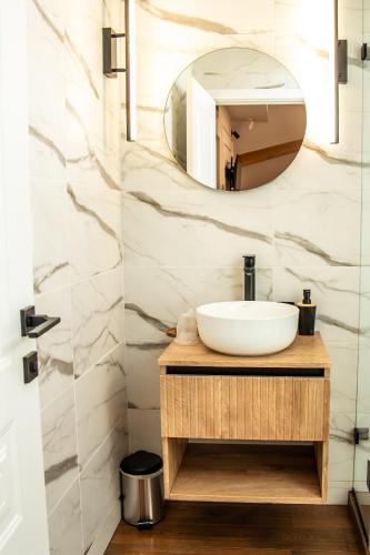 a bathroom with a sink and a mirror at Volotel SkyWay in Cluj-Napoca