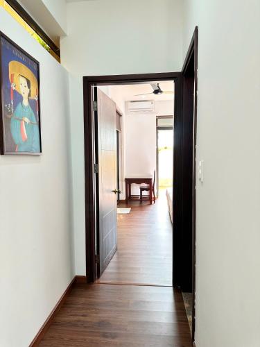 a hallway with a door and a painting on the wall at The Mango Villas in Hoi An