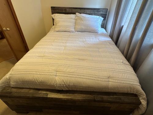 a large bed in a bedroom with a bed frame at Serene home in Gresham