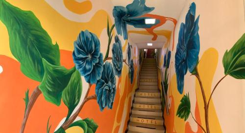 a hallway with a mural of flowers on the wall at HOTEl LAS FLORES in Santa Rosa de Cabal