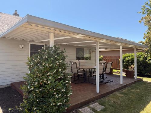 a pavilion with a table and chairs on a deck at Serene home in Gresham