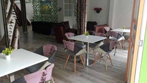 a group of tables and chairs in a room at HOTEl LAS FLORES in Santa Rosa de Cabal
