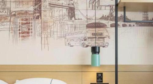 a room with a drawing of a bus on the wall at City Comfort Inn Nanning Nanhu Park Art College in Nanning