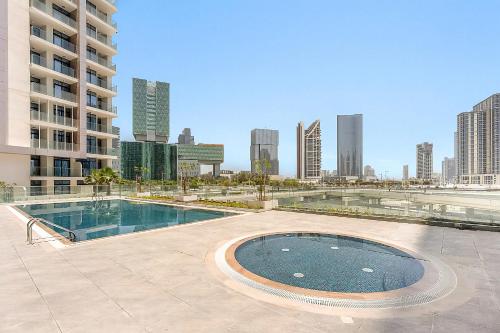 a swimming pool in the middle of a city at Canal View 1BR near Galleria Mall & Cleveland in Abu Dhabi