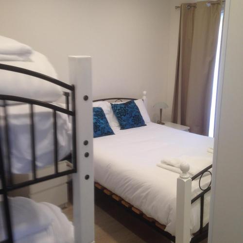 a bedroom with a bed and a bunk bed at Beaches Serviced Apartments in Nelson Bay