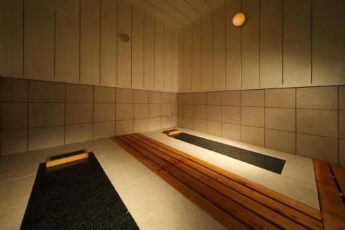 a room with two swimming pools in a building at Tsuganoki in Nikko