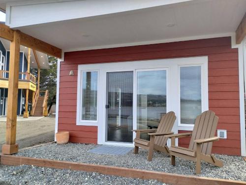 two chairs sitting on the porch of a house at Fireweed Cabin - Homer Seaplane Base in Homer