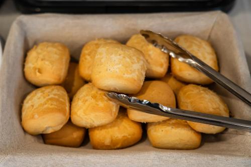 a box of rolls with tongs in it at Volotel SkyWay in Cluj-Napoca