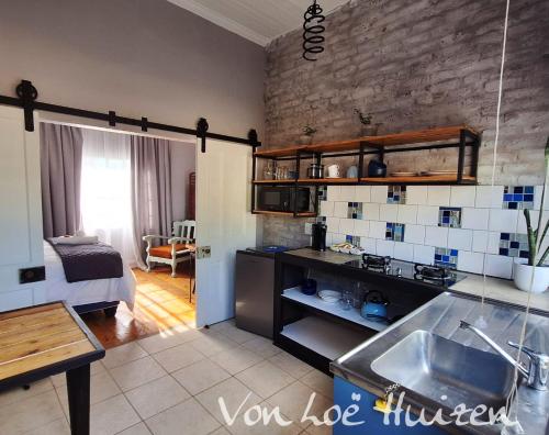 a kitchen with a sink and a counter top at Von Loë Huizen in Fauresmith
