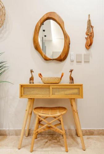 a dressing table with a mirror and a stool at Hotel zone - Private Jacuzzi & Free Beach Club in Tulum
