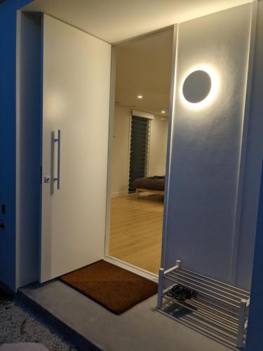 a room with a mirror and a door with a hallway at The White House in Suffolk Park