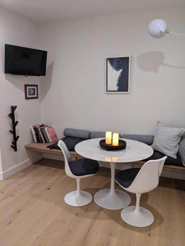 a living room with a table and chairs and a couch at The White House in Suffolk Park
