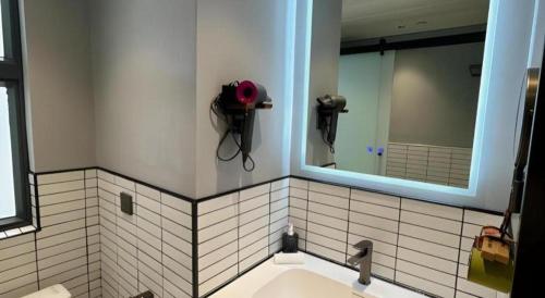 a bathroom with a sink and a mirror at Harbour Bay Hotel in Hong Kong