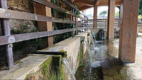a water fountain in front of a building at ハイ沖縄金武店トイレお風呂共用 プレオープン中駐車場有 ペット同伴可能長期滞在可能2025年10月より車貸し出しサービス有希望であればお申し付けください in Kin