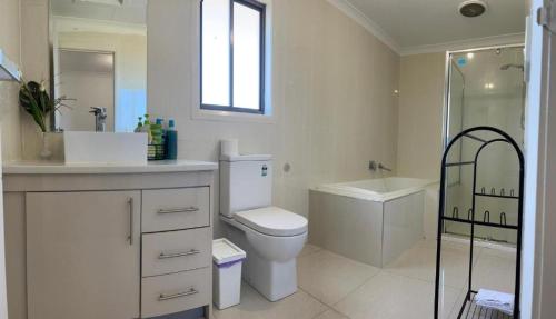 a bathroom with a toilet and a sink and a shower at Room Close Melbourne Airport in Melbourne