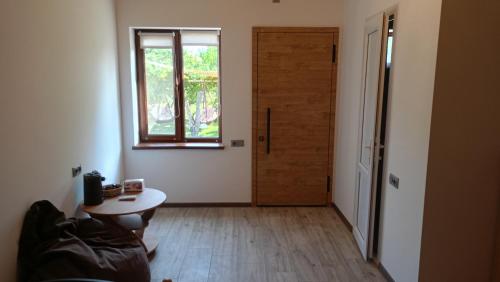 a room with a door and a table and a window at Khachatryan's Guest House in Yeghegnadzor