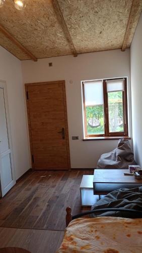 a room with two beds and a door with a window at Khachatryan's Guest House in Yeghegnadzor