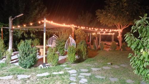 a garden at night with a tent and lights at Khachatryan's Guest House in Yeghegnadzor