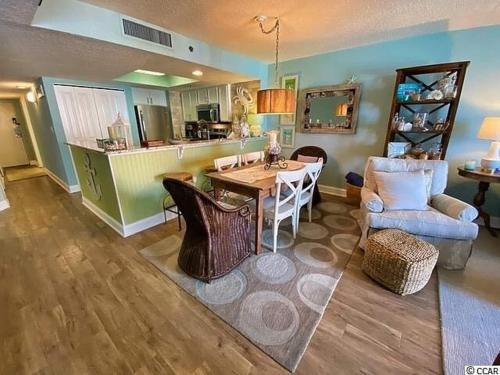 a kitchen and living room with a table and chairs at Ocean View, Near Boardwalk, Pool, Hot Tub in Myrtle Beach