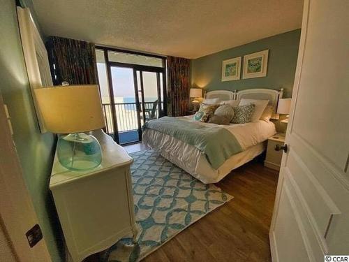 a bedroom with a bed with a view of the ocean at Ocean View, Near Boardwalk, Pool, Hot Tub in Myrtle Beach