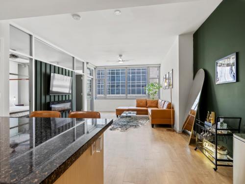 a living room with green walls and a counter top at City View Downtown Dallas High Rise Condo with Free Parking, Gym, Pool in Dallas
