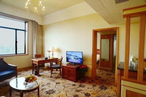 a hotel room with a television and a living room at Beijing Friendship Hotel Jing Bin Building in Beijing