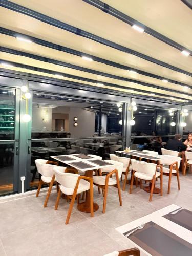 a restaurant with tables and chairs in a room at CLASS PREMİUM hotel in Çanakçılar