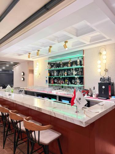 a bar in a restaurant with chairs and a counter at CLASS PREMİUM hotel in Çanakçılar