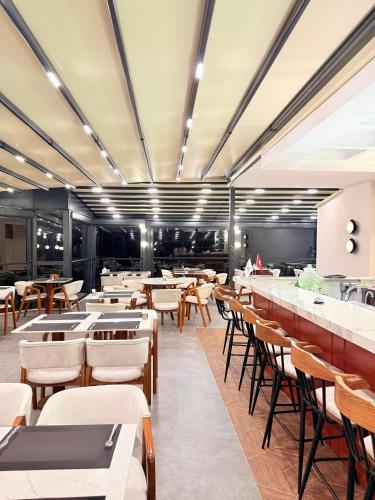 a dining room with tables and chairs and a cafeteria at CLASS PREMİUM hotel in Çanakçılar