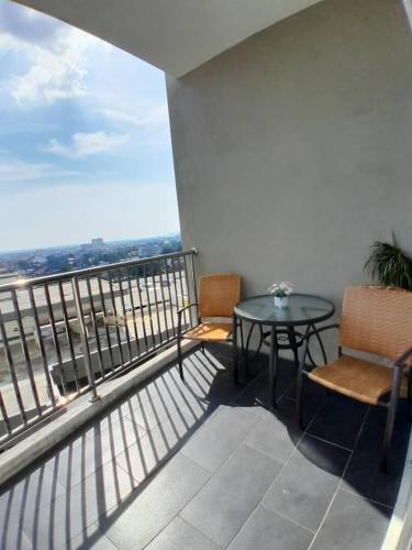 a balcony with a table and chairs and a view at Condominium Crystal Heights in Taiping