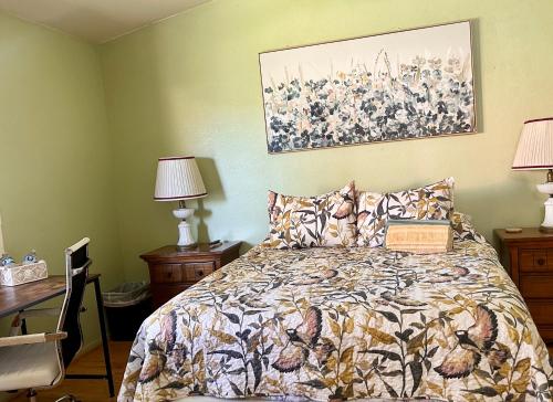 a bedroom with a bed and a painting on the wall at Meadow Harvest Suite with TV and private bathroom in Hemet