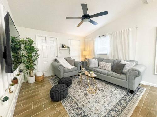 a living room with two couches and a ceiling fan at cozy home in Tampa near Ybor & Busch Gardens in Tampa