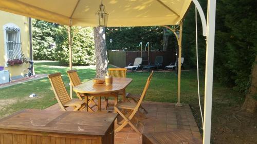 a table and chairs under a tent in a yard at Villa Mirano Bed & Breakfast in Piossasco