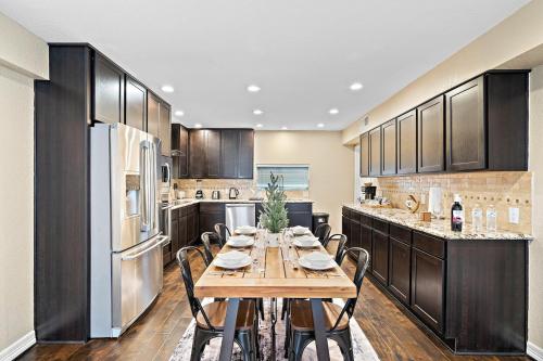a large kitchen with a wooden table and chairs at Nr DT, Med Center, Midtown Sleeps 16 Game Room in Houston